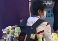 全红婵背了一包玩偶离开杭州 飞机上安静看报+玩游戏